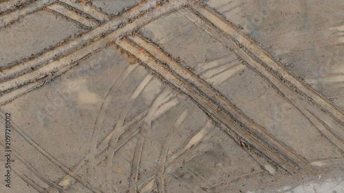 Aerial view wheel tire track on mud, Tire mark imprints on mud vehicles tires footprints transport ground trace or marks textures, wheel treads, Mud terrain.