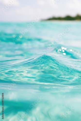 crystal clear turquoise water, gentle waves, tropical island setting, macro photography, cinematic lighting