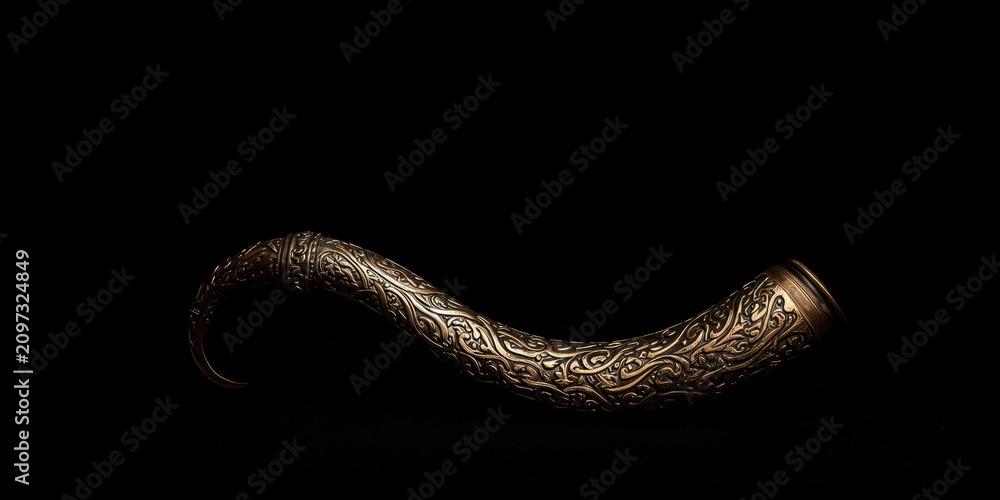 Fototapeta premium Antique Horn Decorated with Intricate Patterns on Black Background