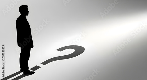 Silhouette of a businessman standing next to a large question mark shadow. Uncertainty and problem solving concept in business