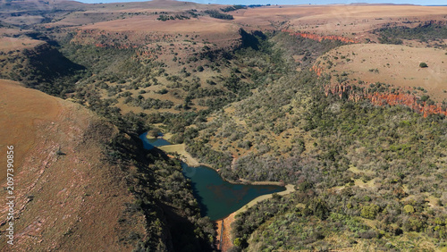 Quadro su tela Scenic drone photograph of Mpumalanga plateau in South Africa, highlighting expansive valleys and sunburnt plains glowing in warm afternoon atmosphere, 2026
