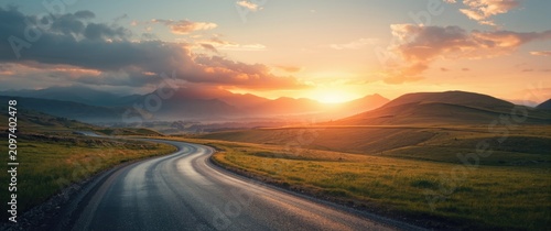 Winding Road Through Hills at Sunset with Dramatic Clouds