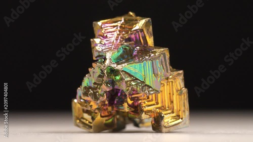 Bismuth crystal. Bismuth - chemical element with symbol Bi and atomic number 83. Post-transition metal and one of pnictogens. Synthesized bismuth crystal. Iridescent coloration is due to oxide film