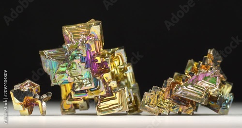 Bismuth crystals. Bismuth - chemical element with symbol Bi and atomic number 83. Post-transition metal and one of pnictogens. Synthesized bismuth crystal. Iridescent coloration is due to oxide film
