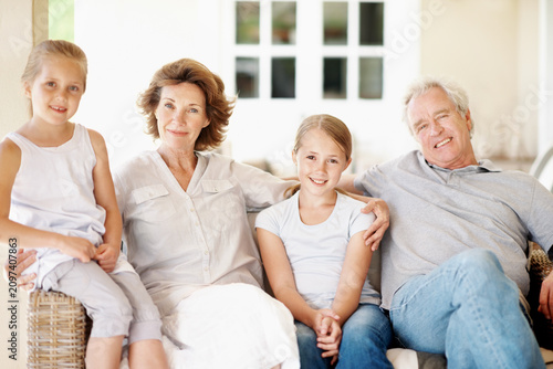 фотографія Grandparents, children and happy portrait in home for bonding together, holiday visit and care