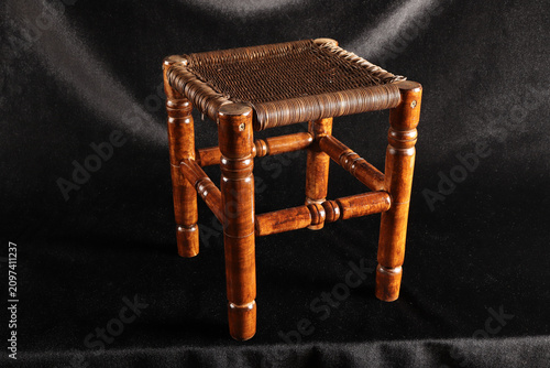 small stool made of wood and wicker