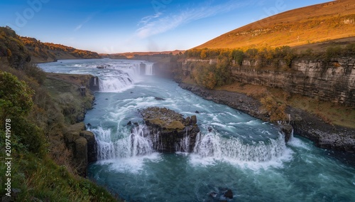 Cascading Waterfalls Flowing into a River in a Scenic Landscape During Sunrise