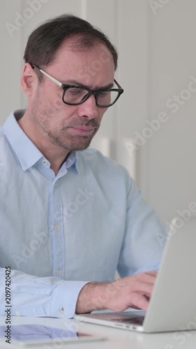 Middle Aged Man with Laptop Shaking Head as No Sign, Vertical Video