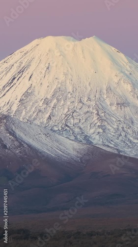 Mount Ngauruhoe, New Zealand. Snow-capped volcano at sunrise. The mountain is a prominent landmark in Tongariro National Park.