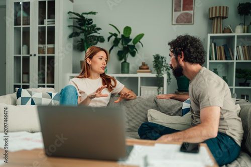 Konstfotografi Couple having serious discussion about financial planning and household budget a