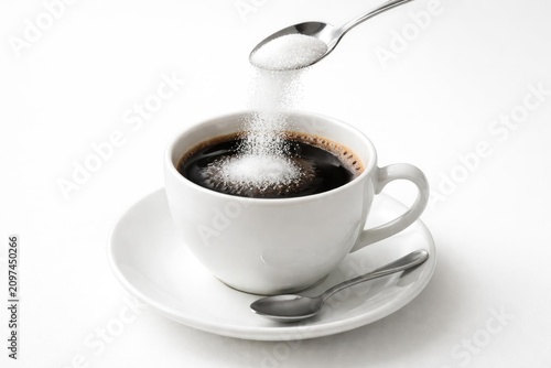 Spoon Pouring Sugar into a ...