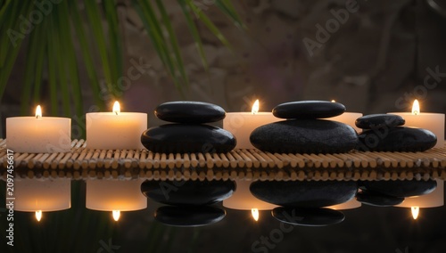 Black stones and candles ar...