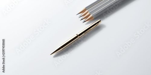 Gold pen beside sharpened p...