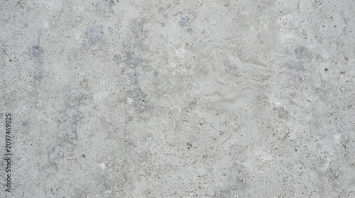 Detailed texture of a smooth grey concrete wall surface with fine grainy particles and subtle mottled patterns for industrial backgrounds