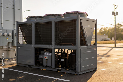 Obraz na płótnie Industrial chiller unit with fans and compressors on a sunny day