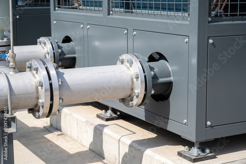 Canvas Print Industrial HVAC unit with large metal pipes and bolted flanges on a rooftop