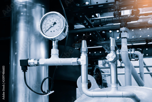 Konstfotografi Industrial pipes and a pressure gauge dominate the scene