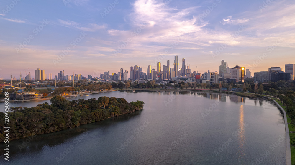 Fototapeta premium Sunrise view of Yarra river and Melbourne skyscrapers business office building with evening skyline in Victoria, Australia