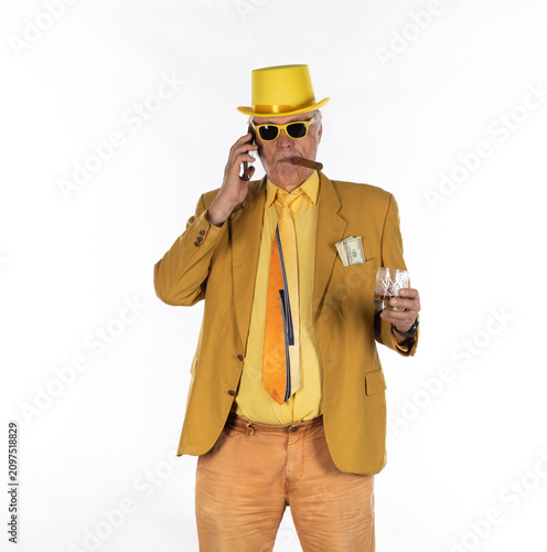 Tableau sur toile Businessman man with cigar in yellow suit isolated on white background