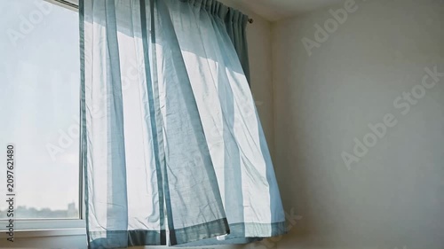 Light Blue Curtains Flowing in a Breeze