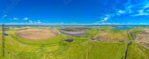 A panoramic shot of a big green field at Rangers Vally Cattle with beautiful blue sky in Australia