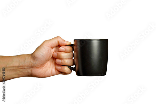 man holding a black ceramic mug with a handle against a white background.