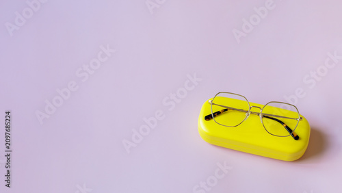 Stylish minimalist optical glasses on bright case. Trendy geometric design for office style and vision correction concept.