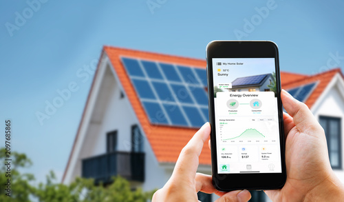 Eco friendly lifestyle. Man monitoring sustainable green electricity production from rooftop solar cells via digital dashboard on phone.