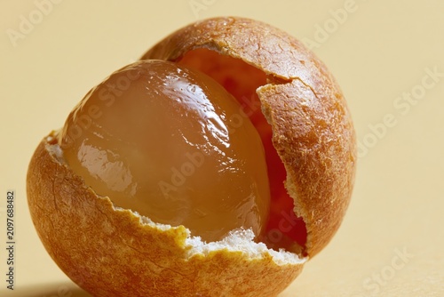 Longan Fruit Shells Cracked Open Amber Tan Exterior Detail Macro Vertical
