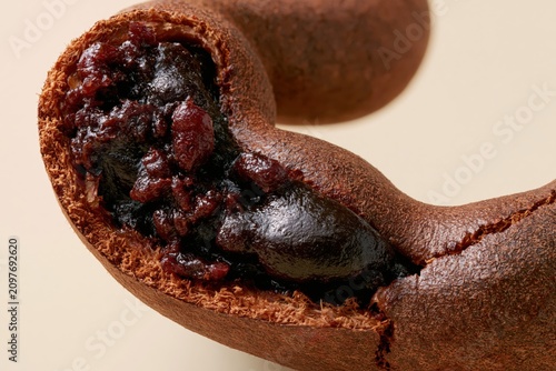 Tamarind Pod Curved Cracked Dark Pulp Red Burgundy Seeds Visible Macro Horizontal