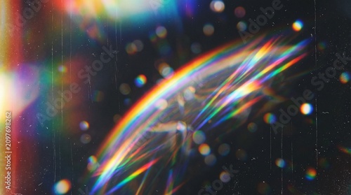 Fotografija Rainbow lens flare with colorful bokeh on dark background with multicolored boke