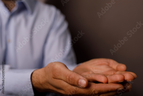 Man's cupped hands open in ...