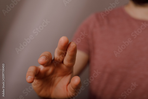 Fotografie Hand reaching out to touch a screen interface, implying digital interaction and engagement