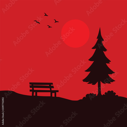 Bench sits under a pine tree while birds fly across a vibrant red sunset in this peaceful landscape.