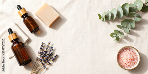 Premium Flat Lay of Natural Herbal Skincare Products with Botanical Soaps, Amber Serum Bottles, Bath Salts, and Fresh Greenery on Soft Pastel Background for Clean Beauty and Wellness Branding