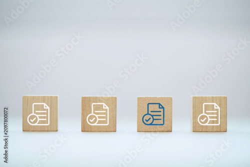 Wooden Blocks with Signs Document evaluation inspect. Contract agreement audit. Assessment survey evaluation check. 