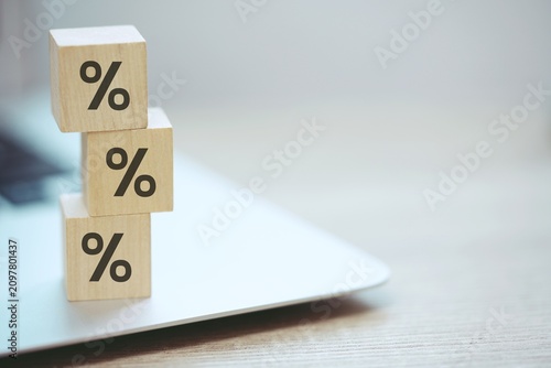 Wooden Blocks with Percentage Signs on computer, Representing Financial Growth, Interest Rates, and Investment Concepts, Emphasizing Economic Strategy and Profit Management. compare, savings, deposit