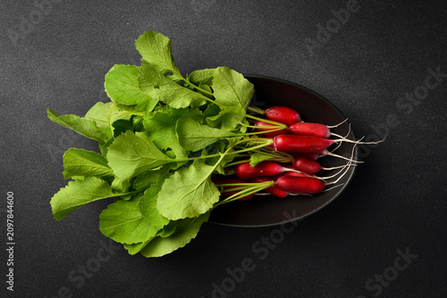 Canvastavla Fresh organic red radish on a black stone plate