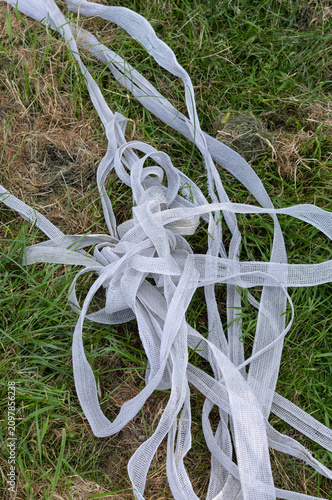 фотографія Electric fencing tape for a horse paddock jumbled up