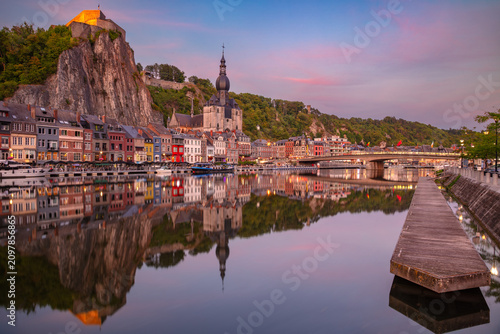Dinant, Belgium. Cityscape image of beautiful historical city of Dinant with the reflection of the city in the Meuse River at summer sunset.
