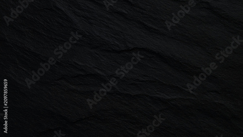 Black slate stone texture background with cracks and scratches