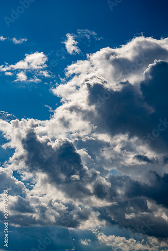 Beautiful dramatic blue sky with contrasting fluffy white and storm clouds. Natural background template for weather forecast, freedom concept, spiritual designs, or travel banners