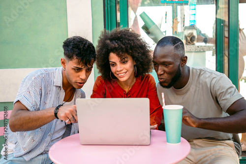 A group of multicultural university friends enjoys online shopping and fun moments together