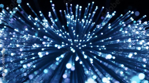 Slow motion zoom into glowing blue fiber optic cables with light bokeh effects and negative space for text placement, representing high speed data transfer and digital connectivity concept