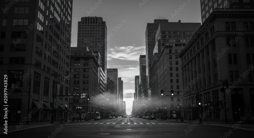 Naklejka premium Cityscape view of buildings along a street in black and white