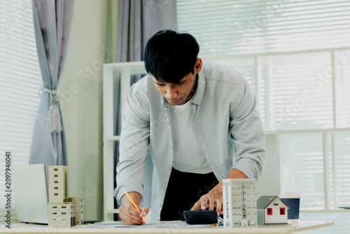 Civil engineer making precise load assessments and cost estimates for an urban development building.