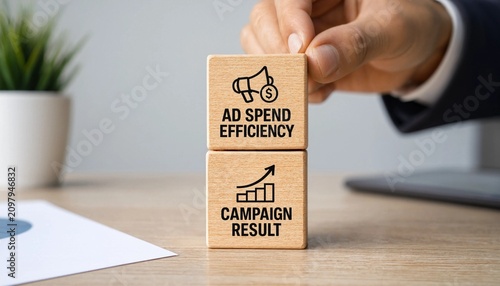 Businessman hand holding wooden block with ad spend efficiency and campaign result on desk with laptop and plant  marketing strategy and optimization concept