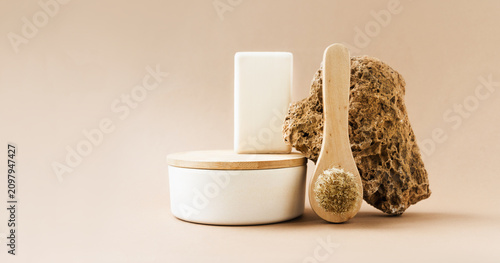 Natural beauty products with brush, soap, and stone