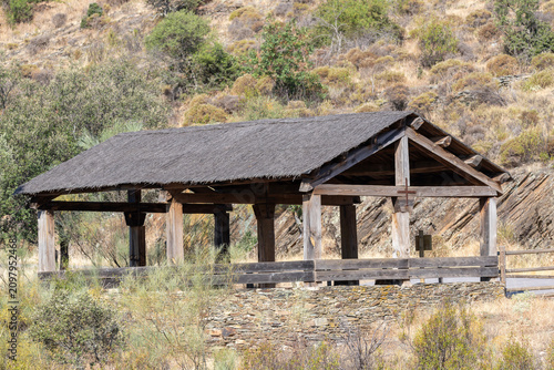 фотографія Rustic wooden shelter standing in the rocky natural landscape of Monfrague Natio