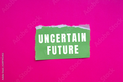 Bild auf Leinwand Ripped green paper displaying uncertain future text, placed on a vibrant pink background
